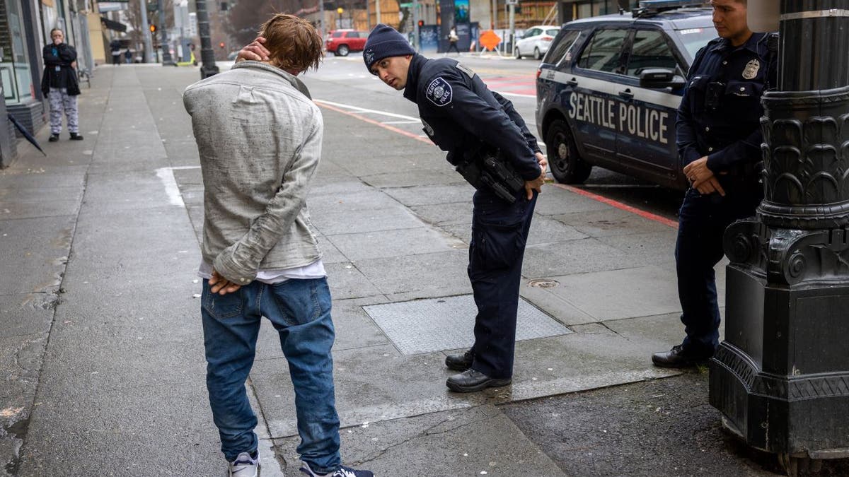 police officers talk to suspect