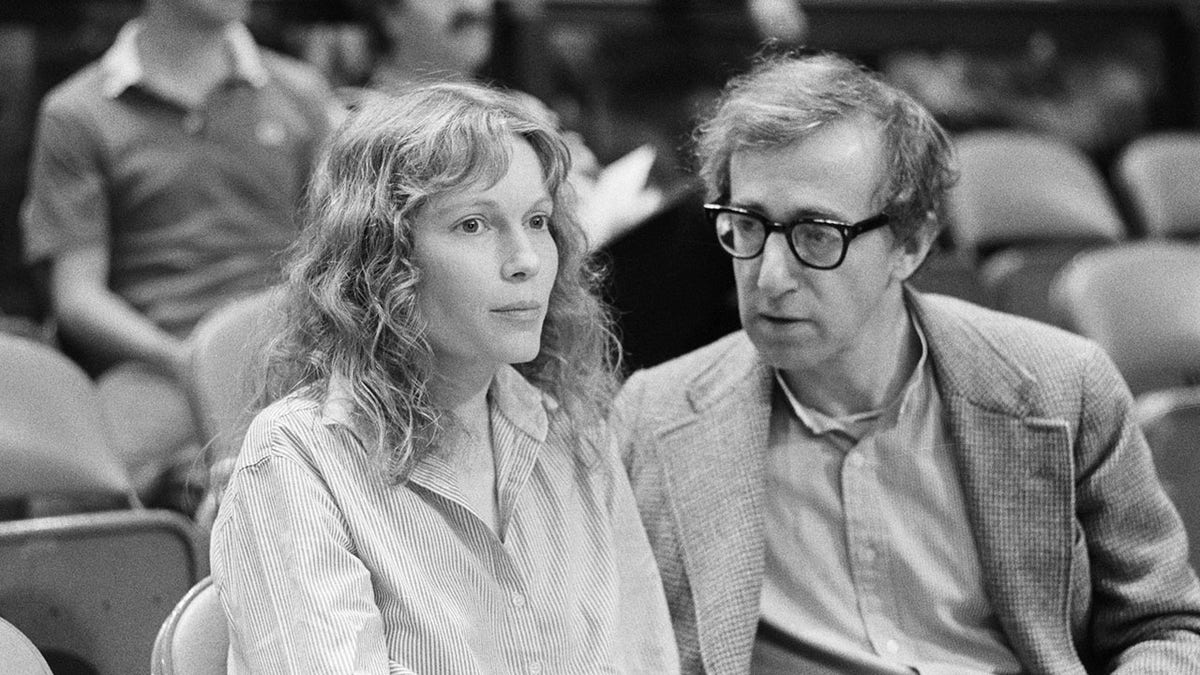 Mia Farrow sitting next to Woody Allen