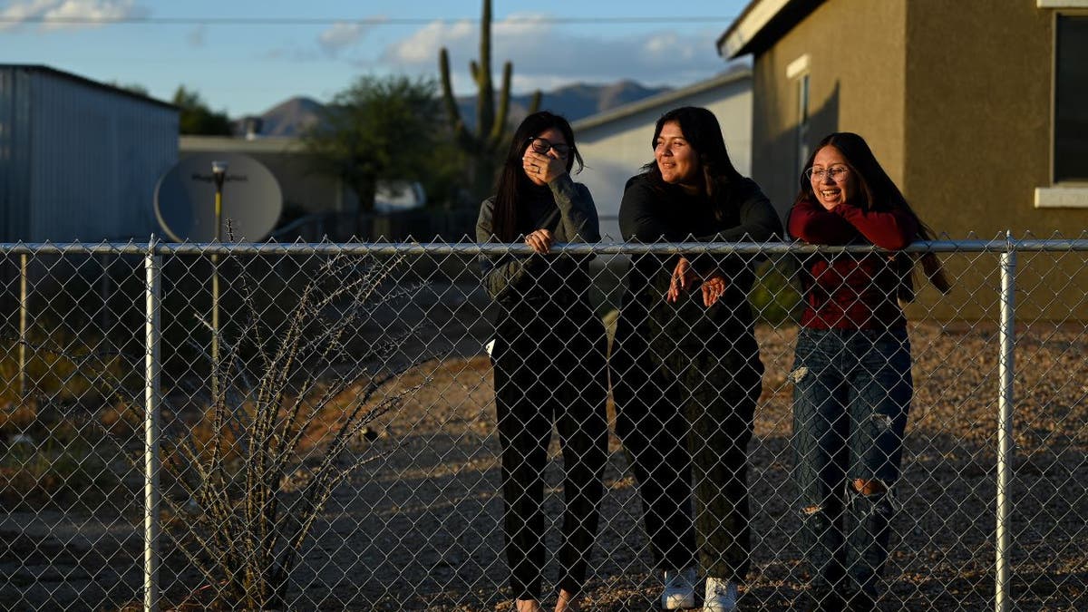 Native American girls at fence