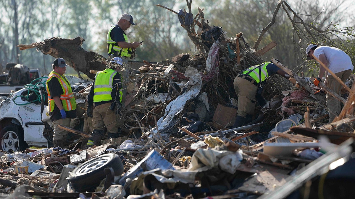 crews digging through wreckage