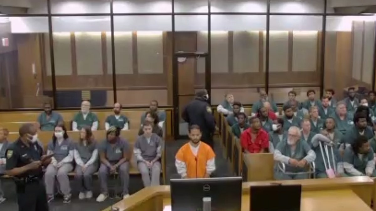 Mario Fernandez wears an orange jail-issue jumpsuit in court.