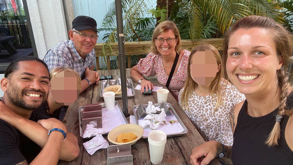 Group of people smiling at a table.