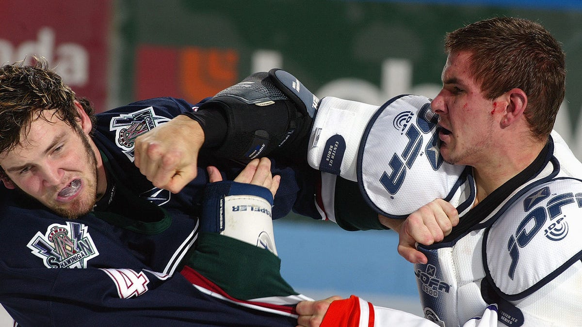 Marty Doyle fights during a hockey game