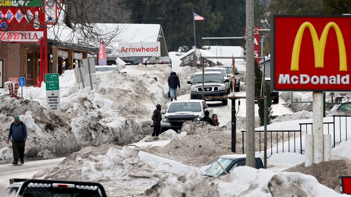 People walk through plowed streets in Crestline