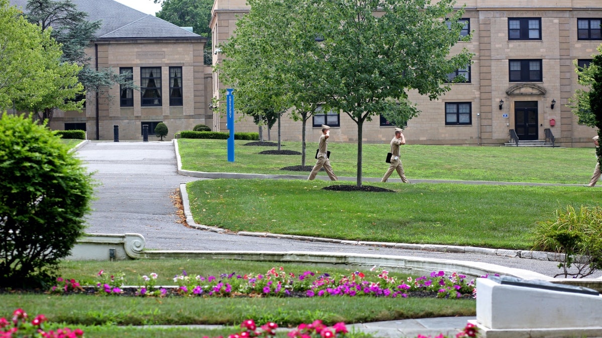 Photo of Merchant marines saluting while walking on campus