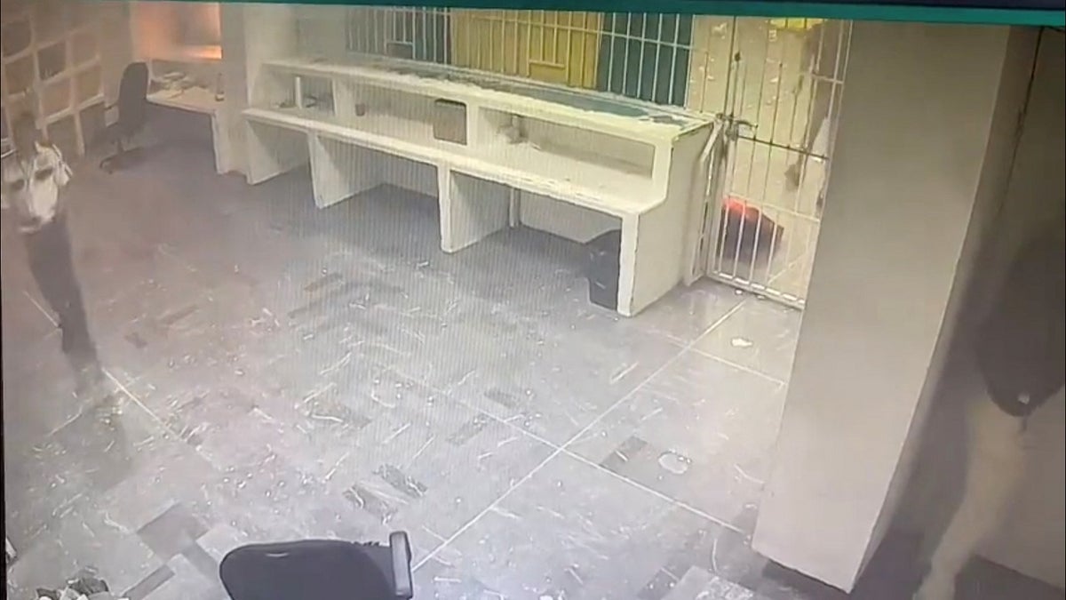 Mexico migrant facility fire is seen in surveillance video; guard is seen walking away