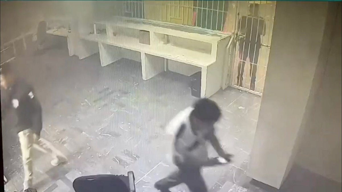 Mexico migrant facility fire is seen in surveillance video; guard is seen walking away