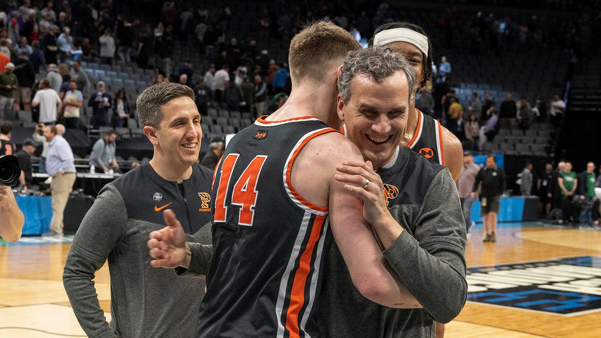 Mitch Henderson hugs Matt Allocco