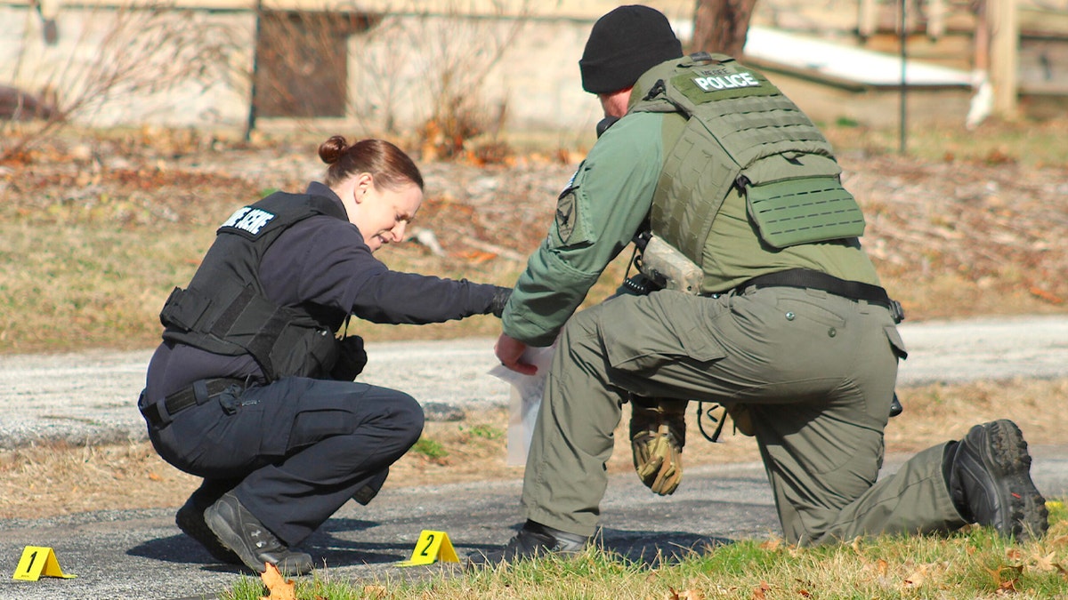 Police examine evidence on the ground