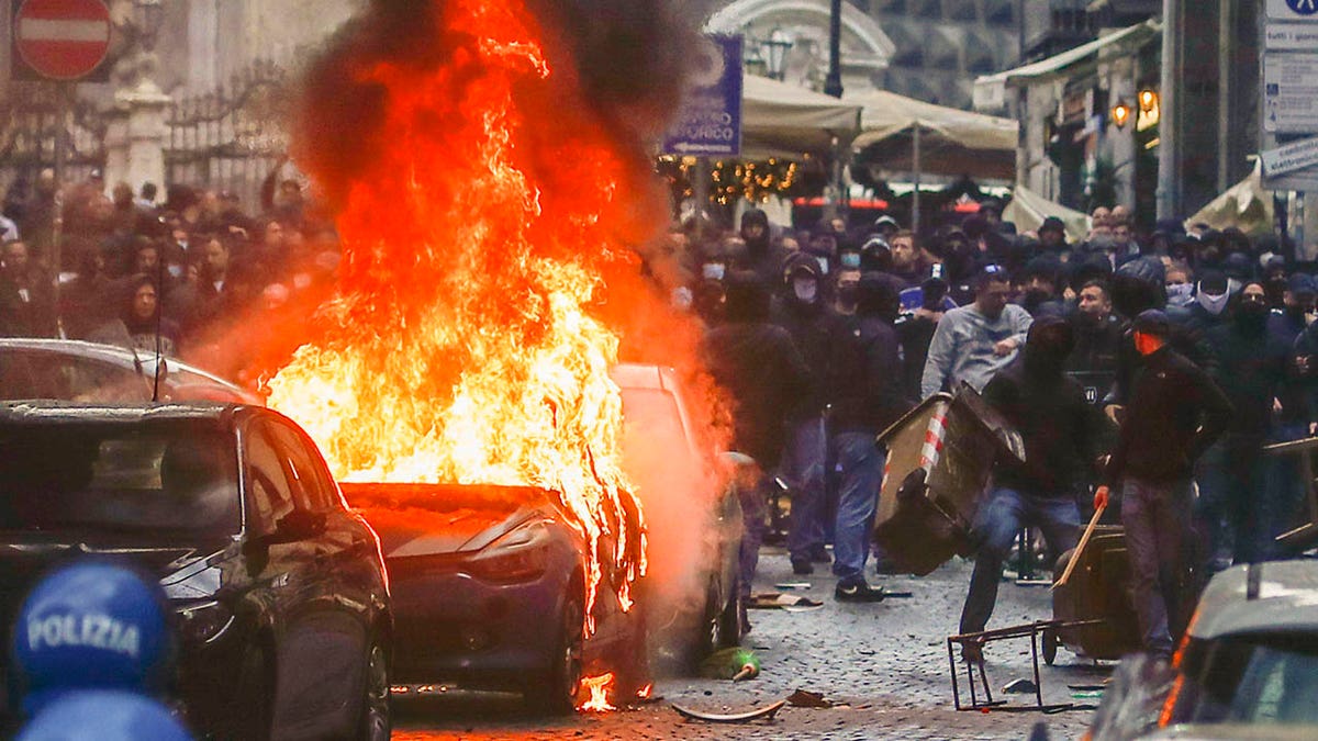 Supporters near a burning car