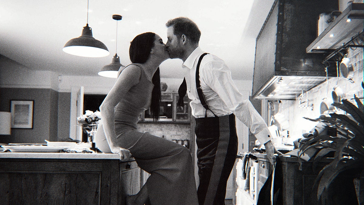 A black and white photo of Meghan Markle and Prince Harry kissing from their Netflix documentary