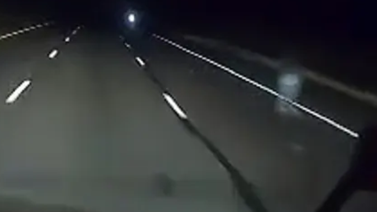 Closer screenshot of a Nexar dashcam showing a mysterious figure on the side of an Arizona road
