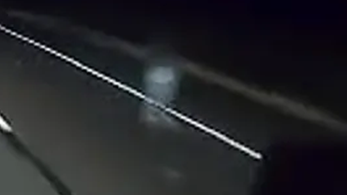 An extreme close-up screenshot of a Nexar dashcam showing a mysterious figure on the side of Arizona State Route 87 in March 2023