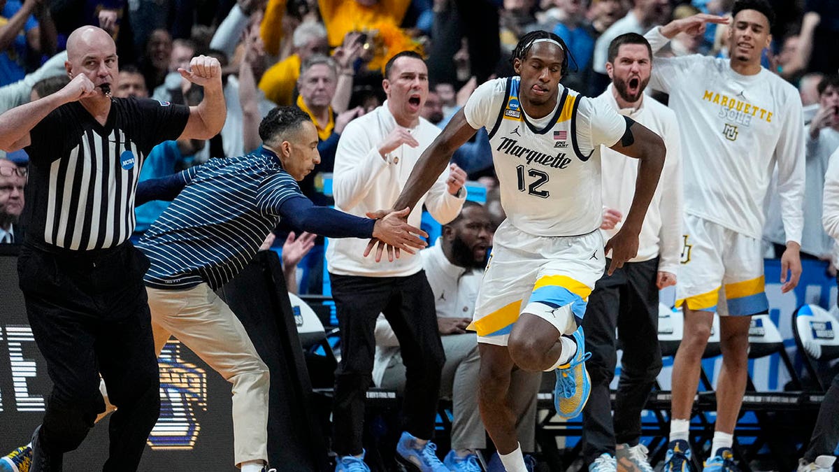 Olivier-Maxence Prosper shakes hands with Shaka Smart