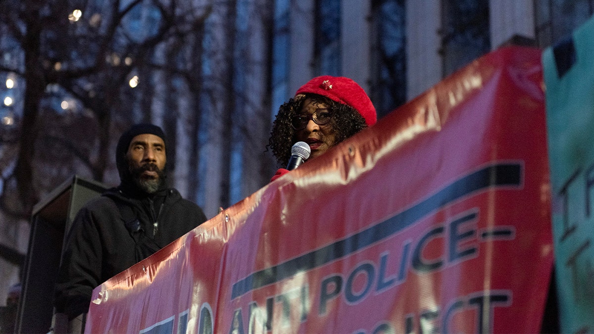 Pamela Price holds microphone and addresses rally 