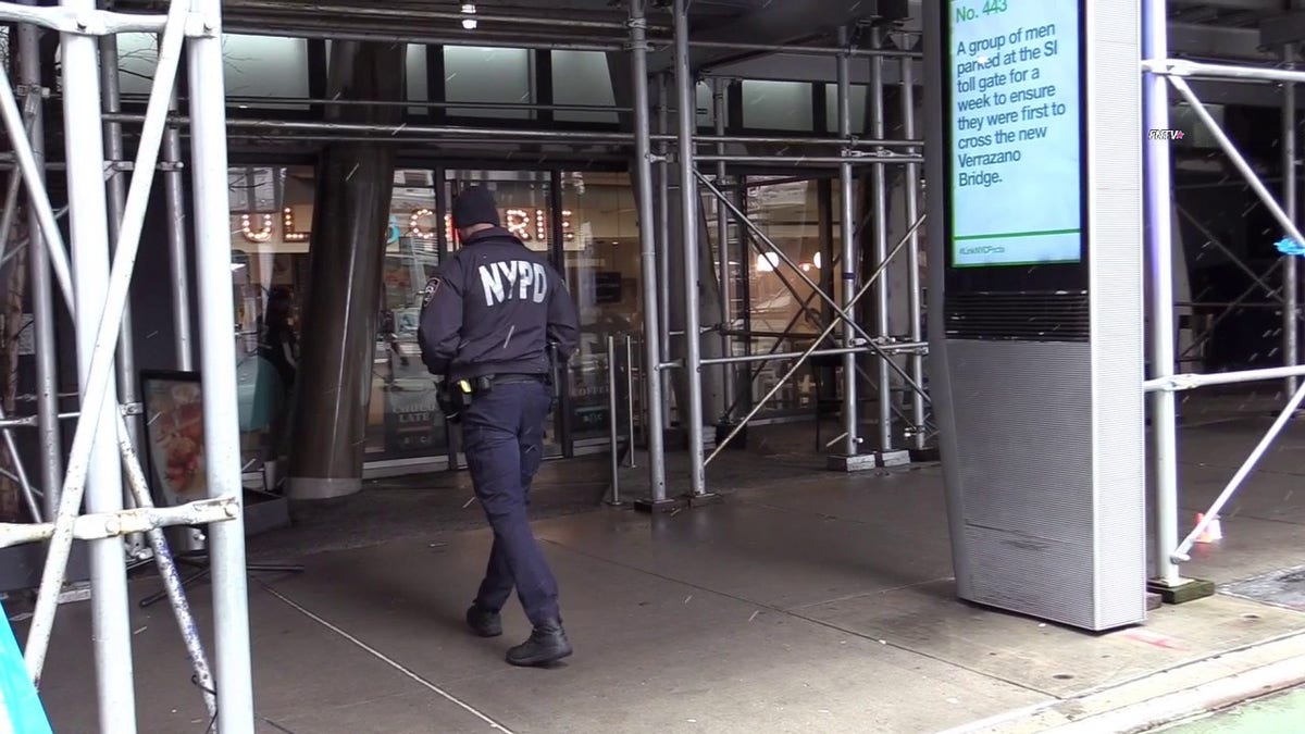 NYPD officer walking near scene of shooting