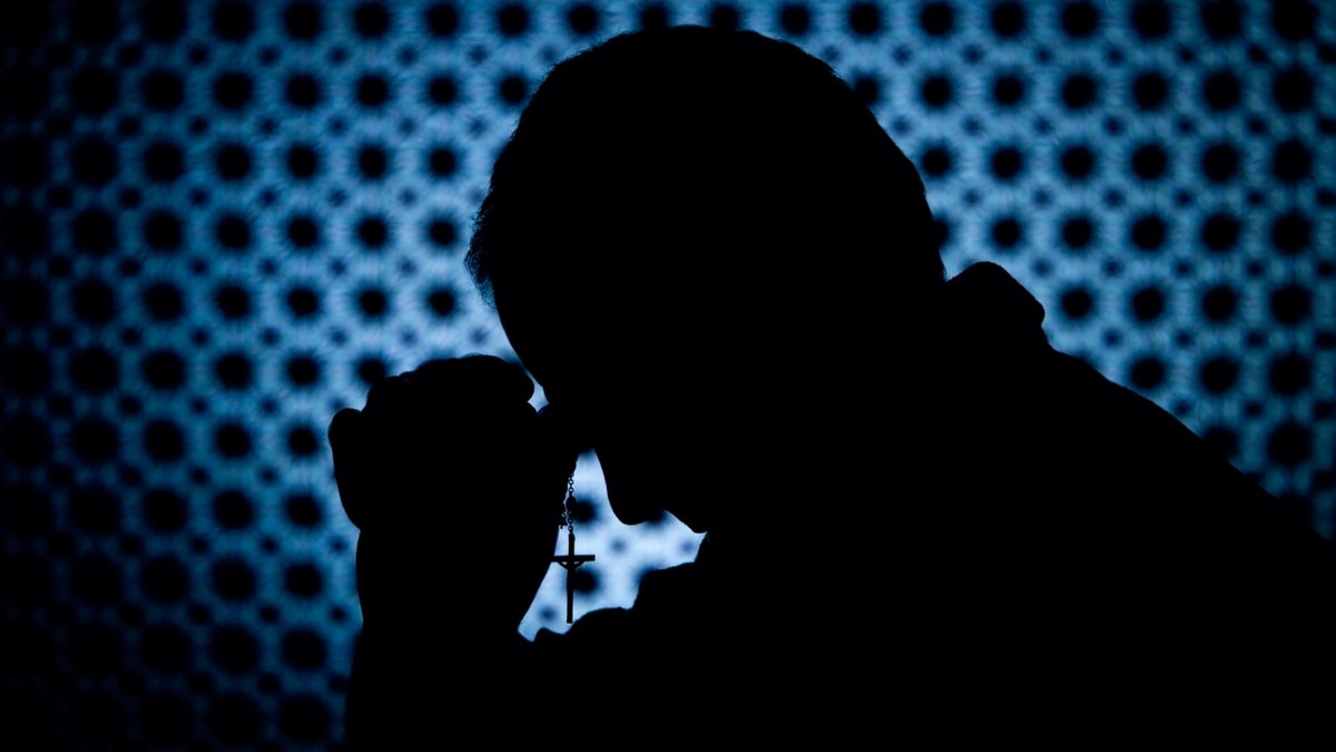 priest in confessional silhouette 