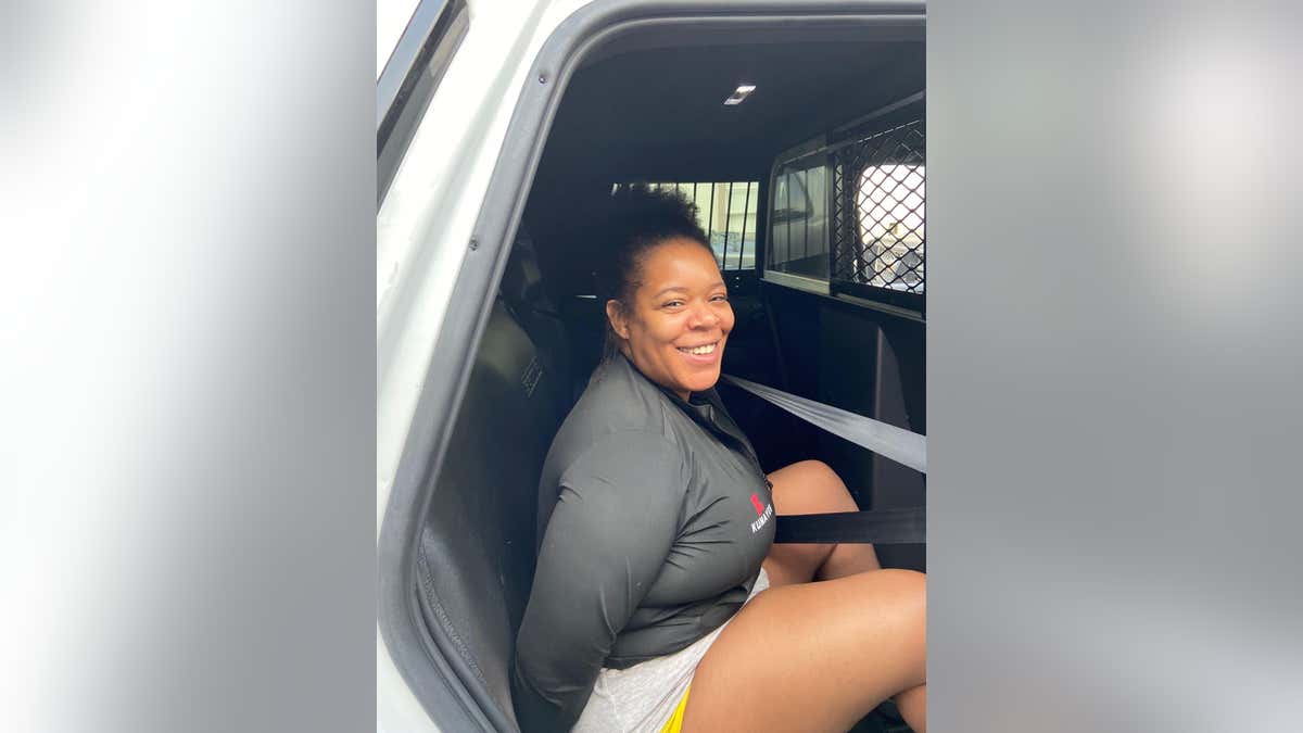 Raven Yates smiles during arrest