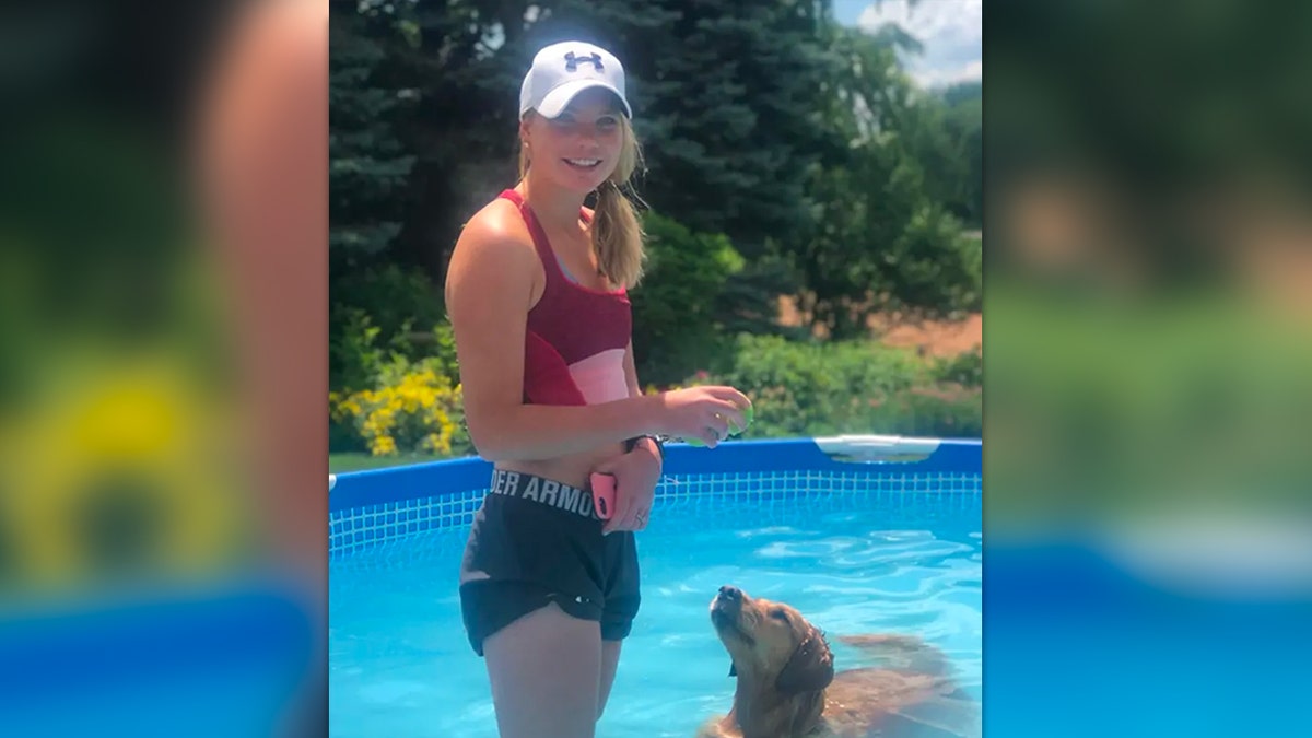 Julia Pernsteiner and dog in pool