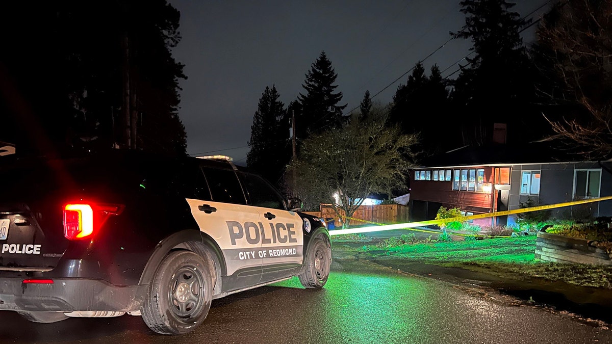 Police SUV, crime tape outside victims' home