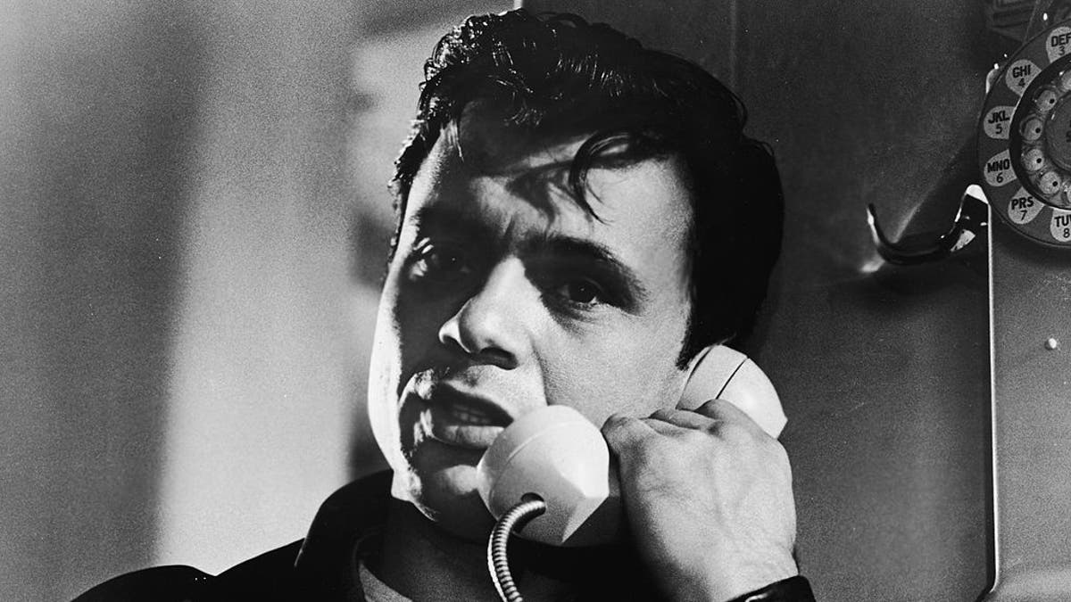 Robert Blake talks on a payphone for scene of In Cold Blood