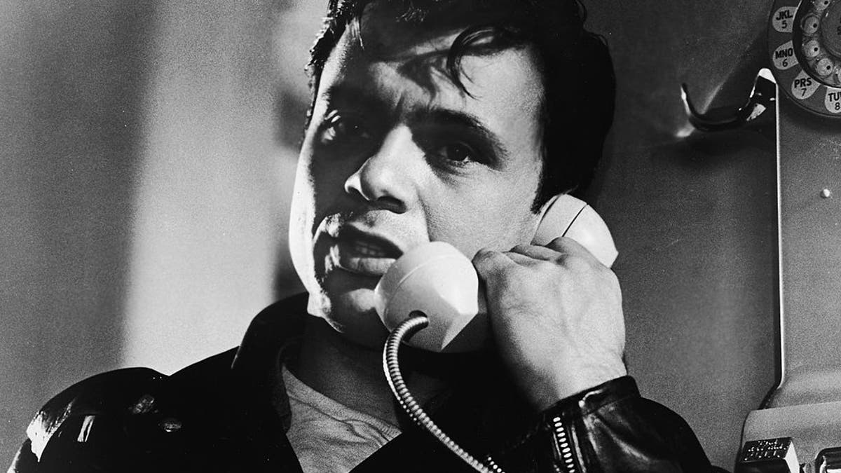 Robert Blake talks on a payphone for scene of In Cold Blood