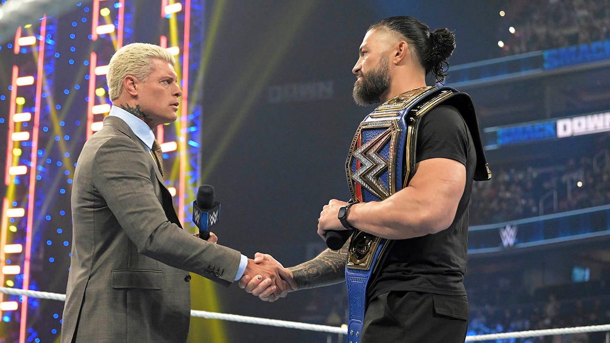 Roman Reigns and Cody Rhodes shake hands