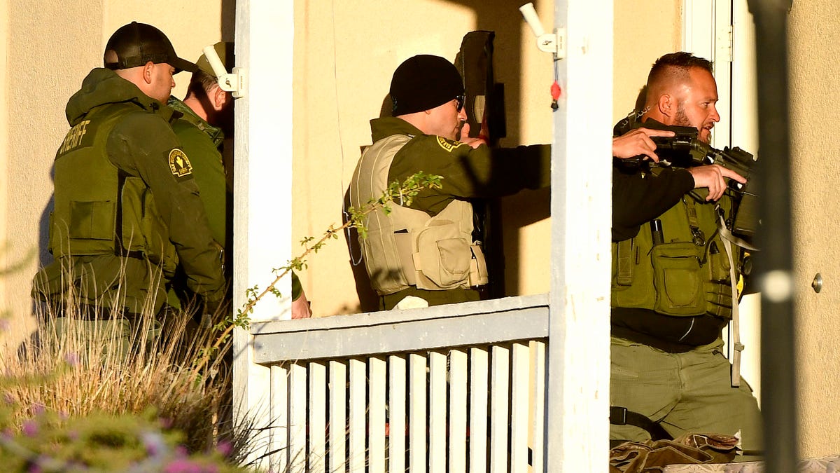 Sergeant Debevek leads a raid into a home