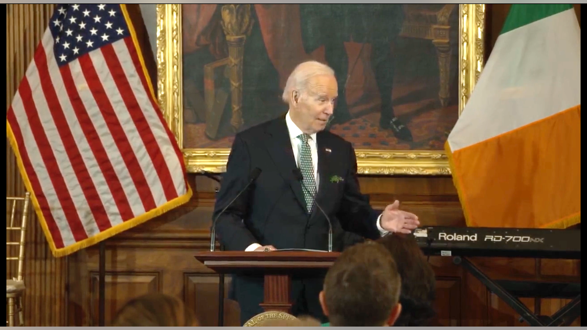 President Biden in front of American and Irish flags