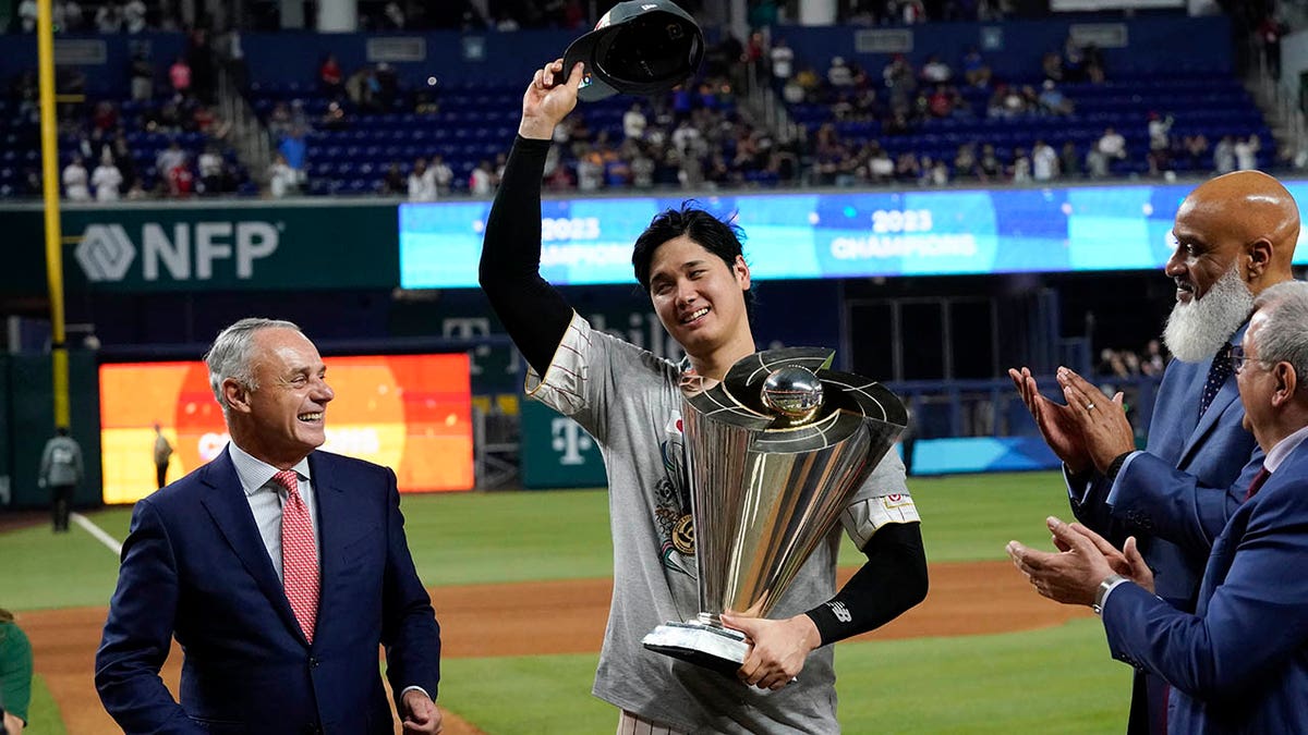 Japan's Shohei Ohtani carries the national flag during a pregame ceremony  before the World Baseball Classic final against the United States in Miami,  Florida, on March 21, 2023. (Kyodo)==Kyodo Photo via Credit