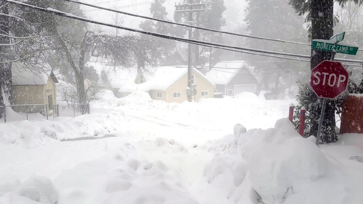 Snow blankets a street in Crestline