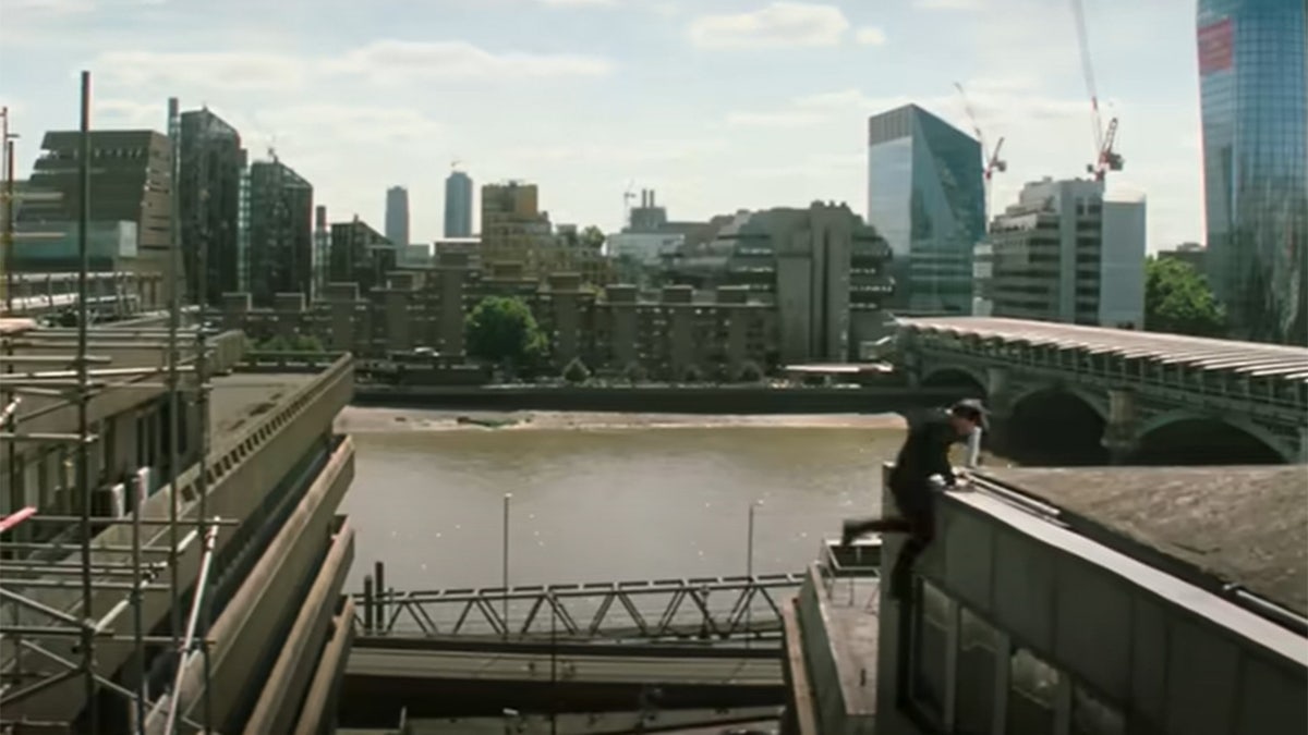 Tom Cruise jumping from a building in a stunt for Mission Impossible: Fallout