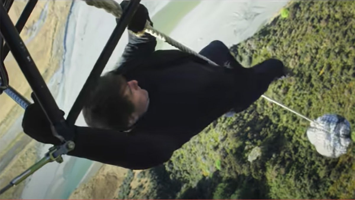 Tom Cruise hanging on a rope attatched to a flying helicopter for a stunt in Mission Impossible: Fallout