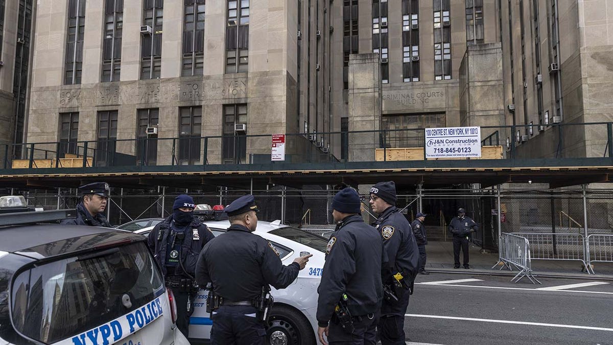 Police gather outside of a Manhattan courthouse after news broke that former President Donald Trump has been indicted