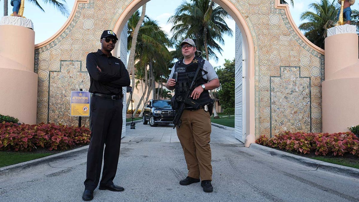 A Secret Service agent and a security guard officer guard the Mar-a-Lago home of former U.S. President Donald Trump