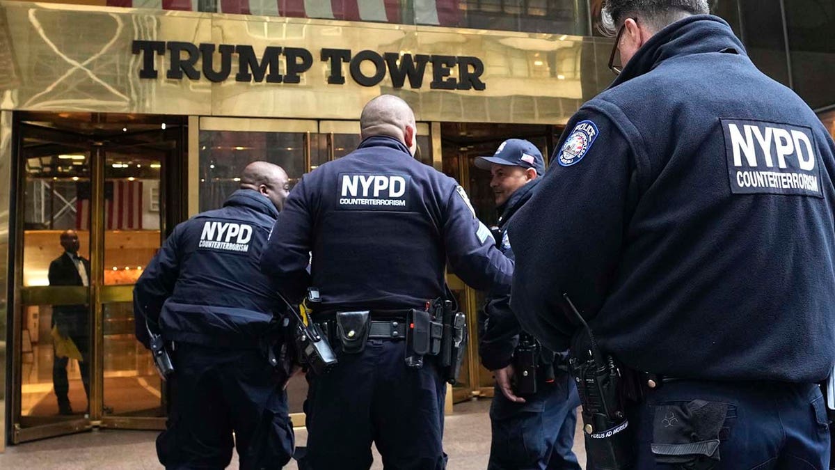 Several members of the NYPD enter Trump Tower