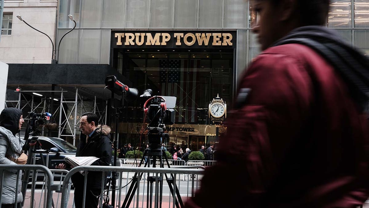 People walk by Trump Tower the morning after former president Donald Trump was indicted