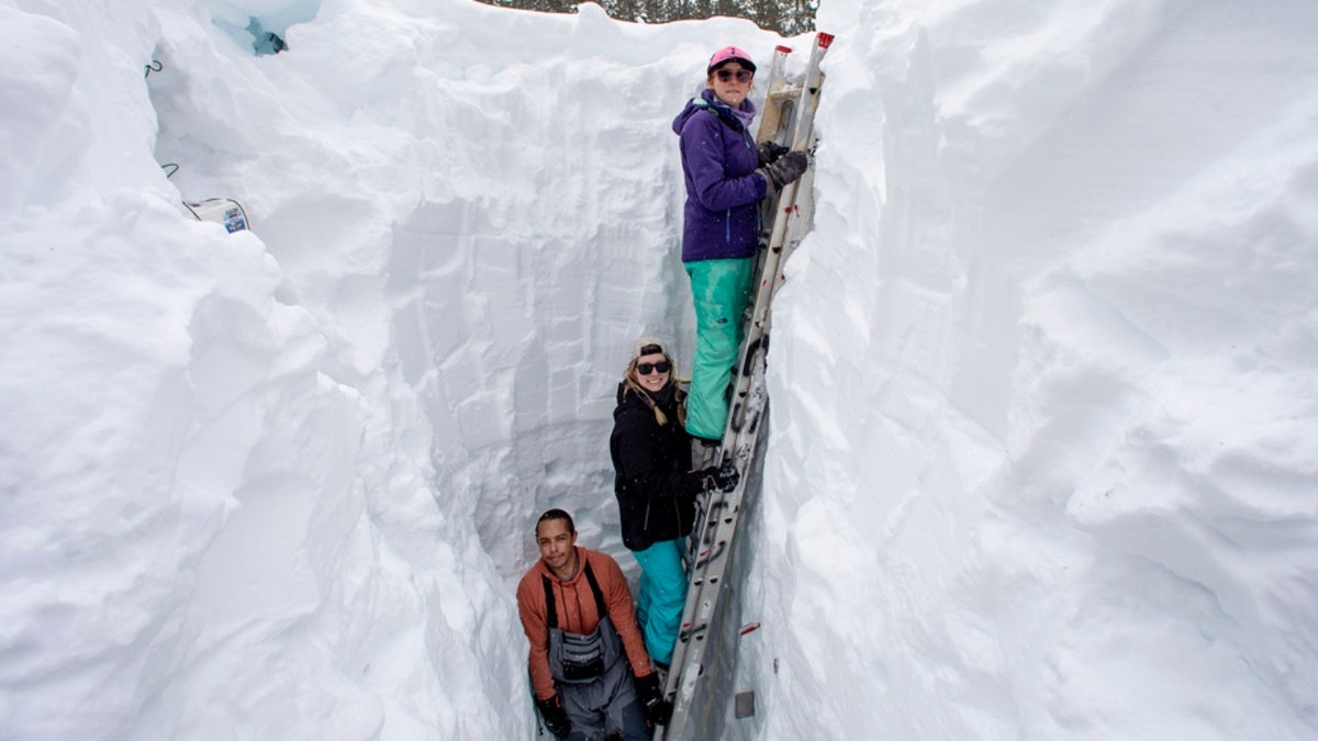 The UC Berkeley Central Sierra Snow Lab works in a snow pit