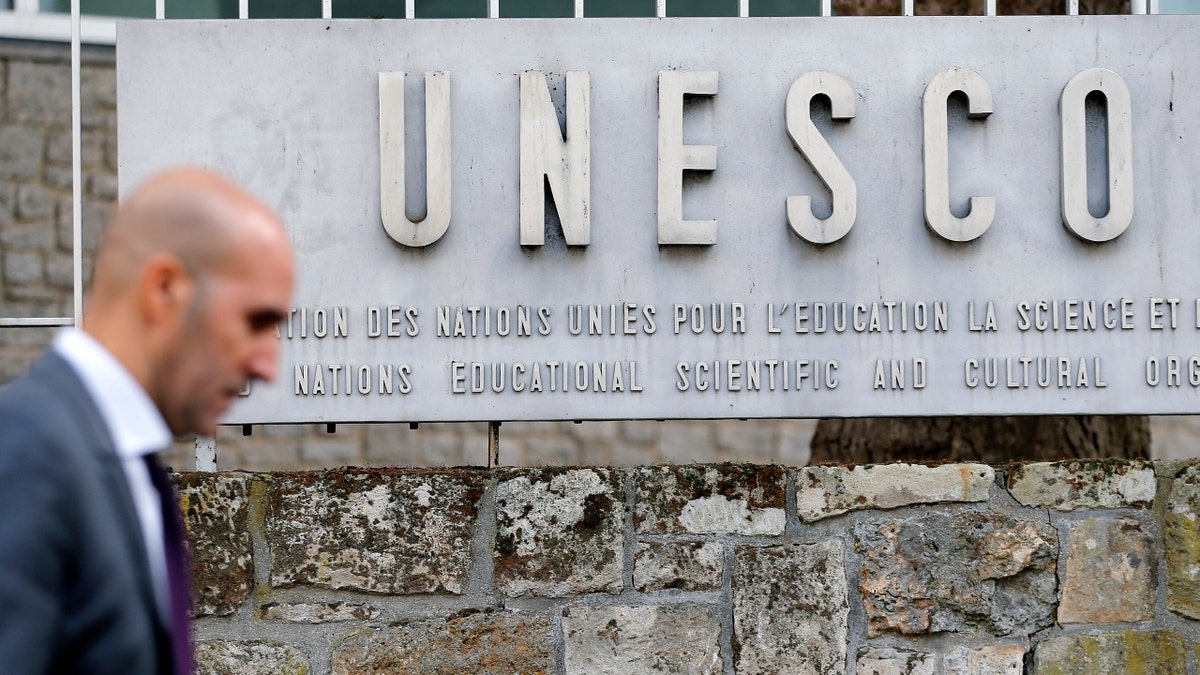 A man walks by the UNESCO headquarters in Paris, France