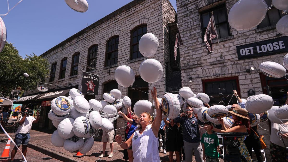 People release balloons in memory of Doug Kantor in downtown Austin