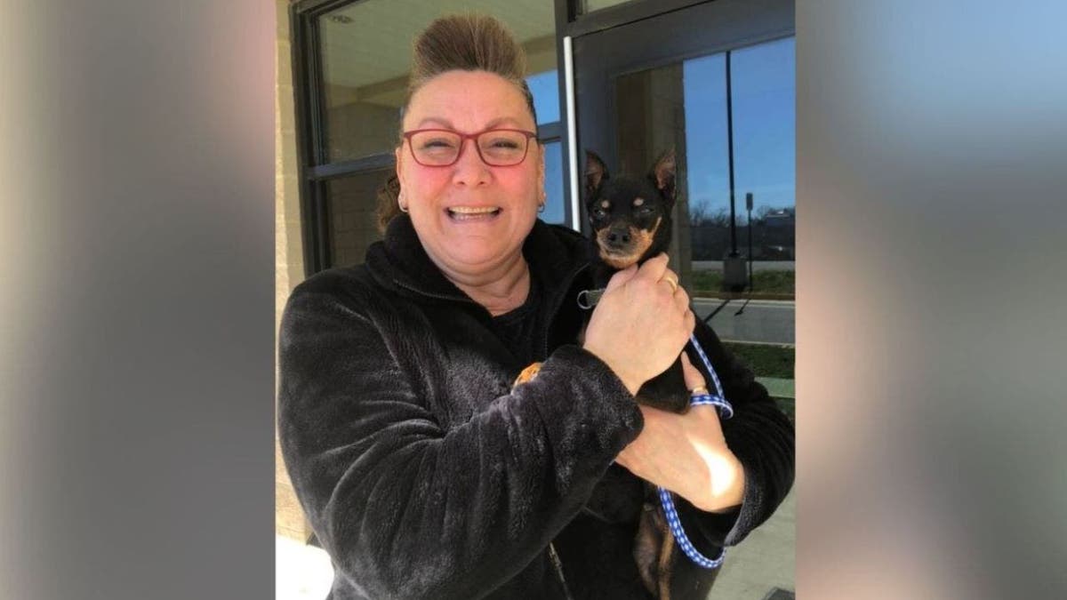 woman holds her dog Starsky