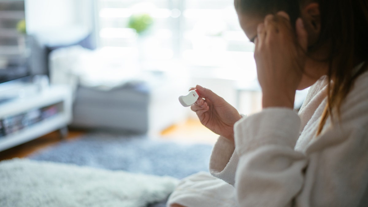 Woman with pregnancy test