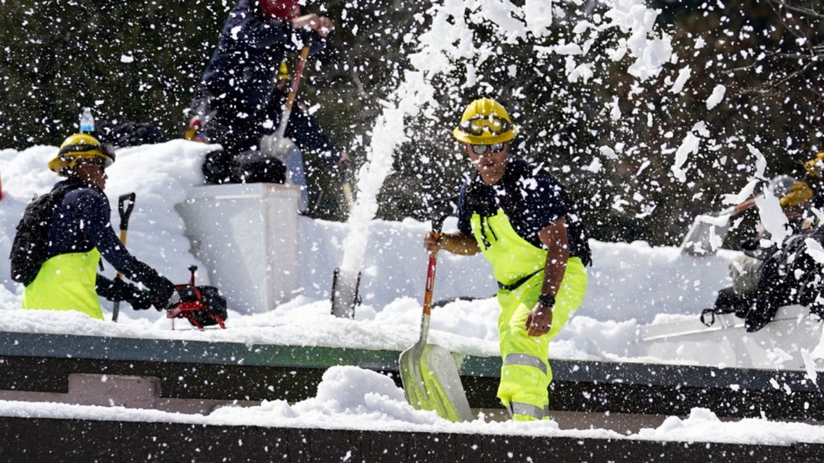 A Cal Fire crew clears snow in Crestline, Calif.