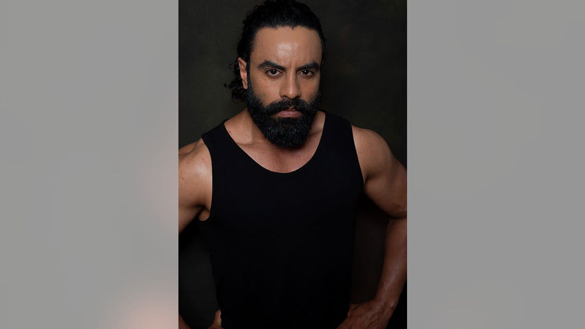 Aman Dhaliwal wears black tank in photo