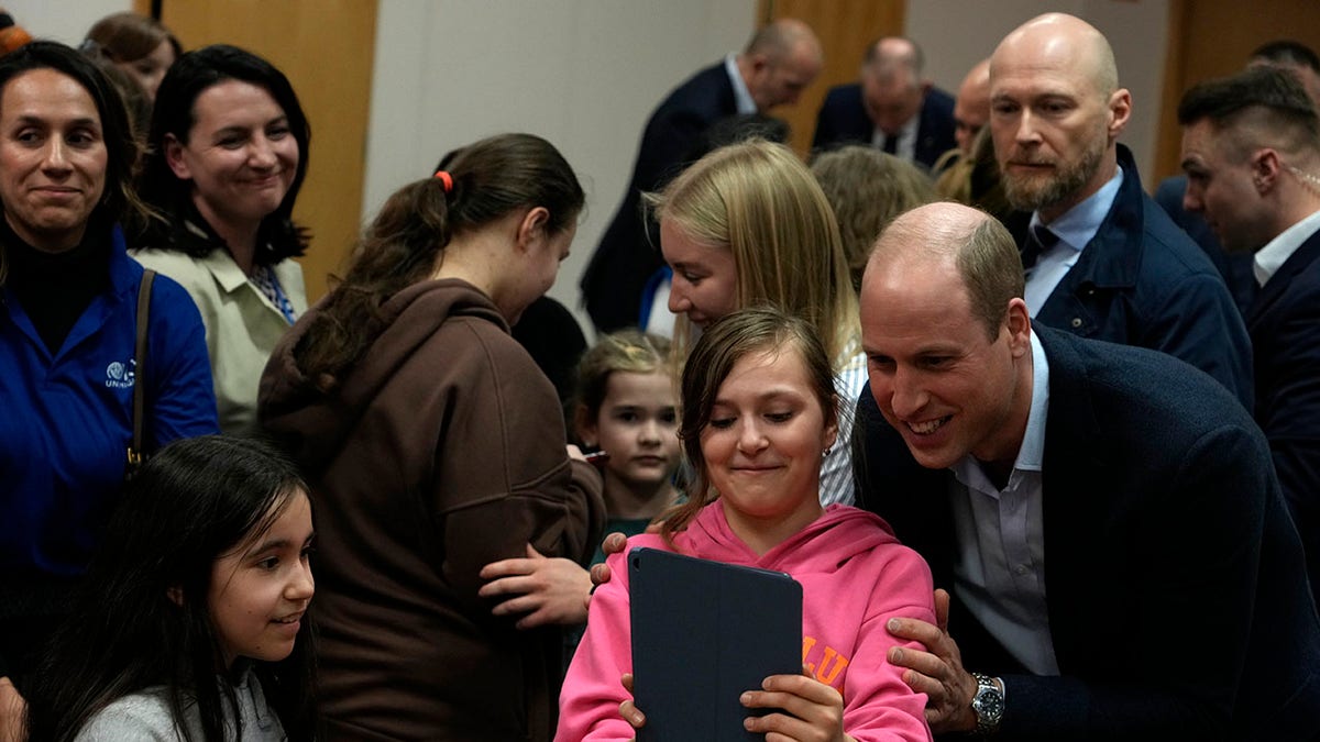 Prince William taking selfies with kids