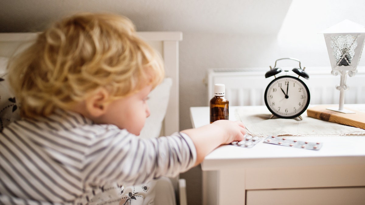 Baby playing with pills