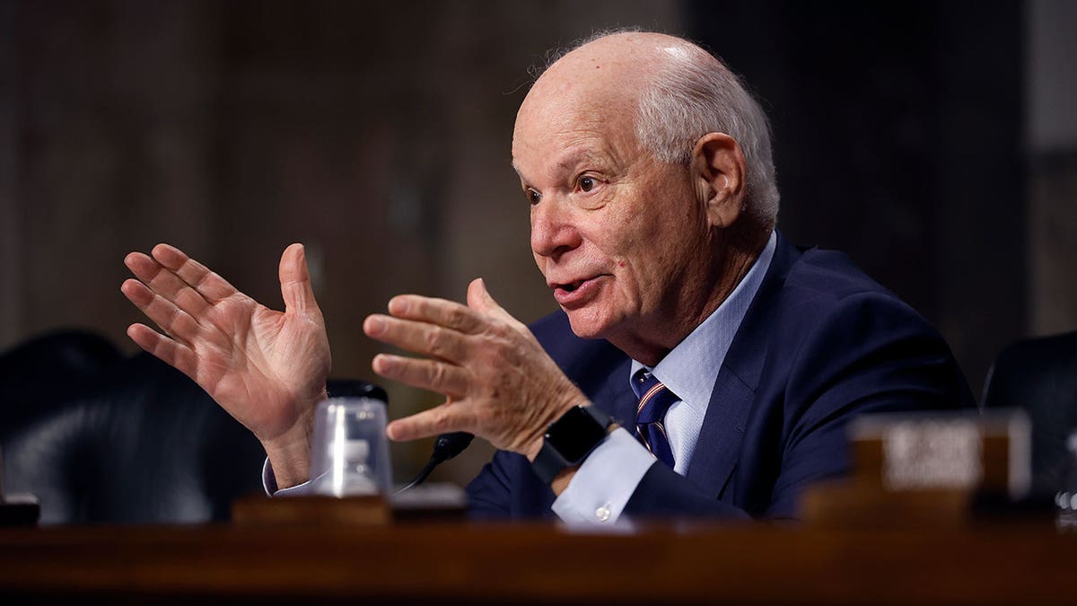 Sen. Ben Cardin raises hands during hearing