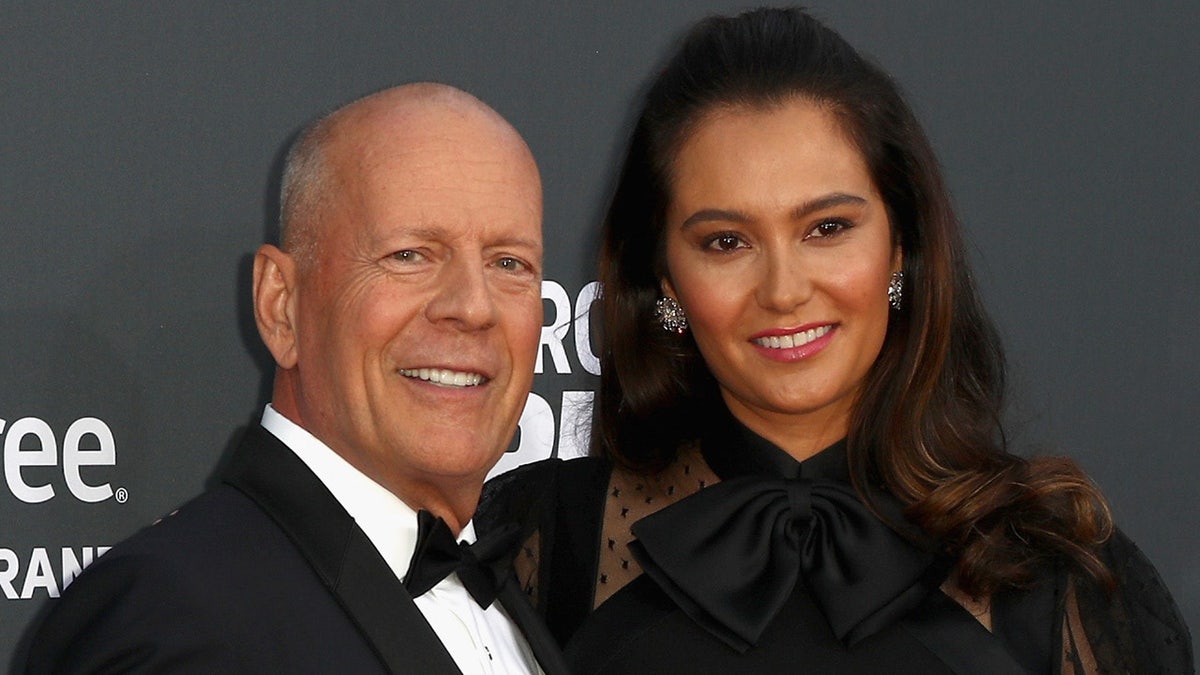 Bruce Willis and wife Emma Heming walk red carpet in black tie attire