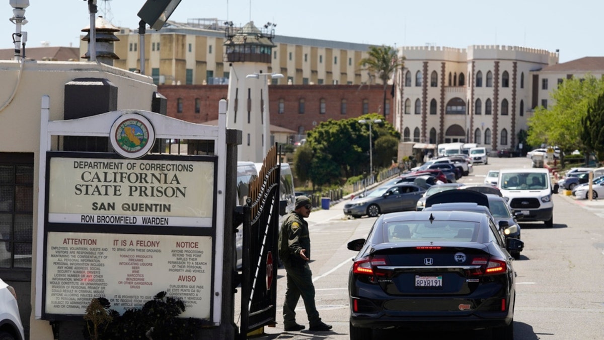 A guard checks vehicles at San Quentin's entry gate