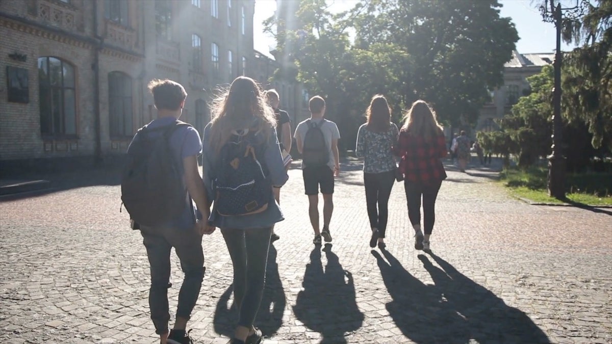 Students with backpacks walking